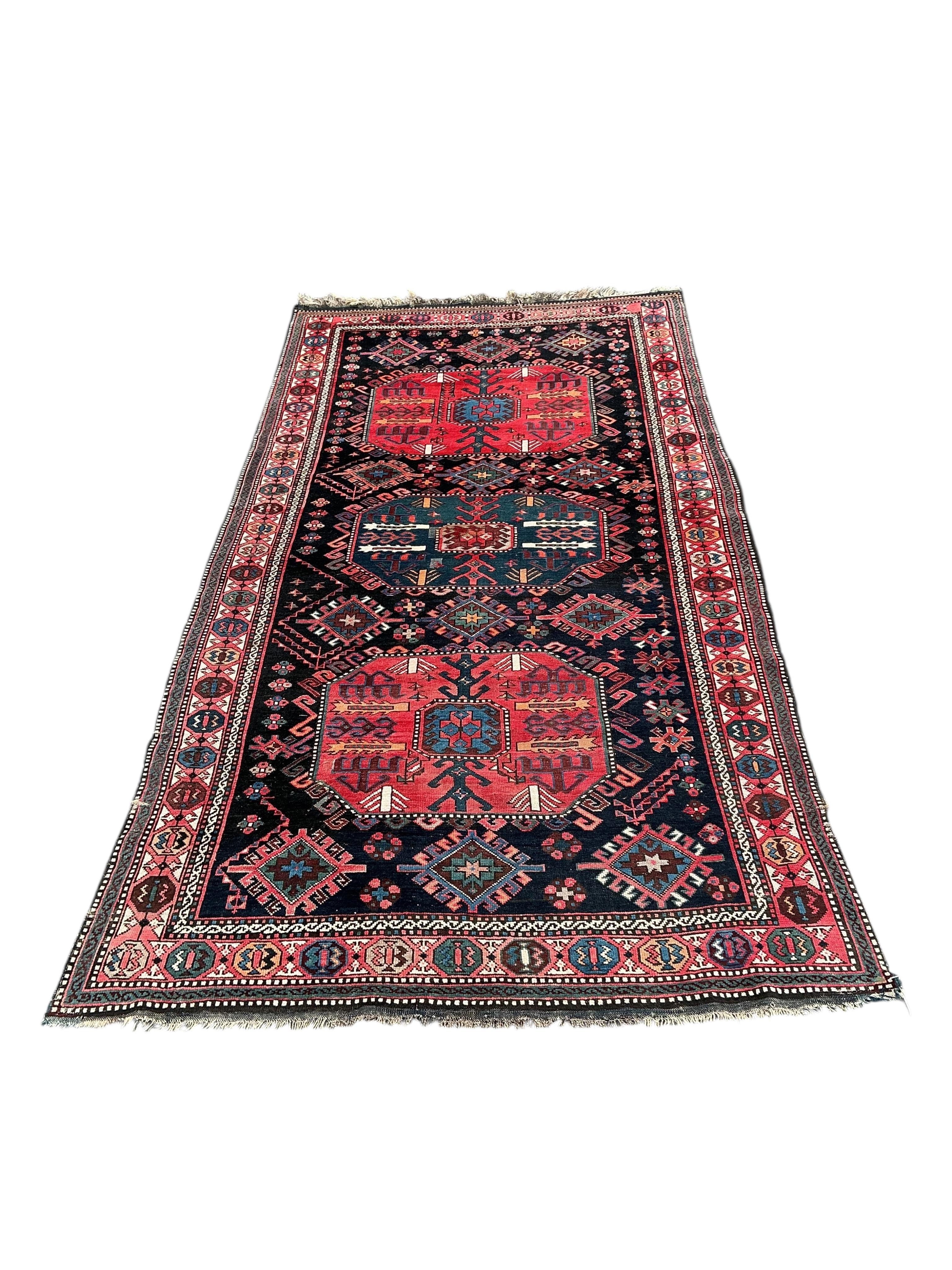 An antique Caucasian blue ground rug, 280 x 140cm